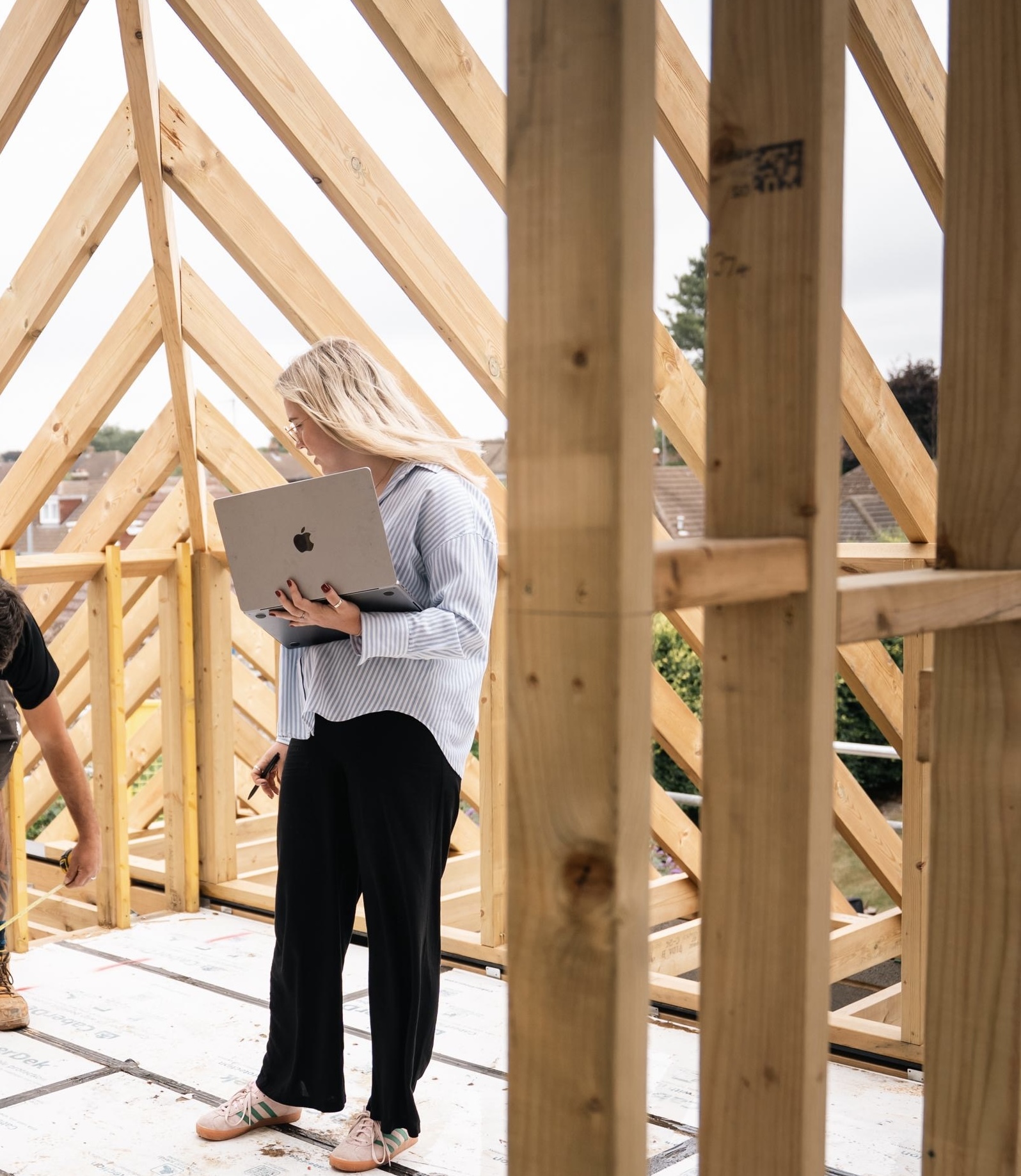 Designer on site within a newly framed timber structure