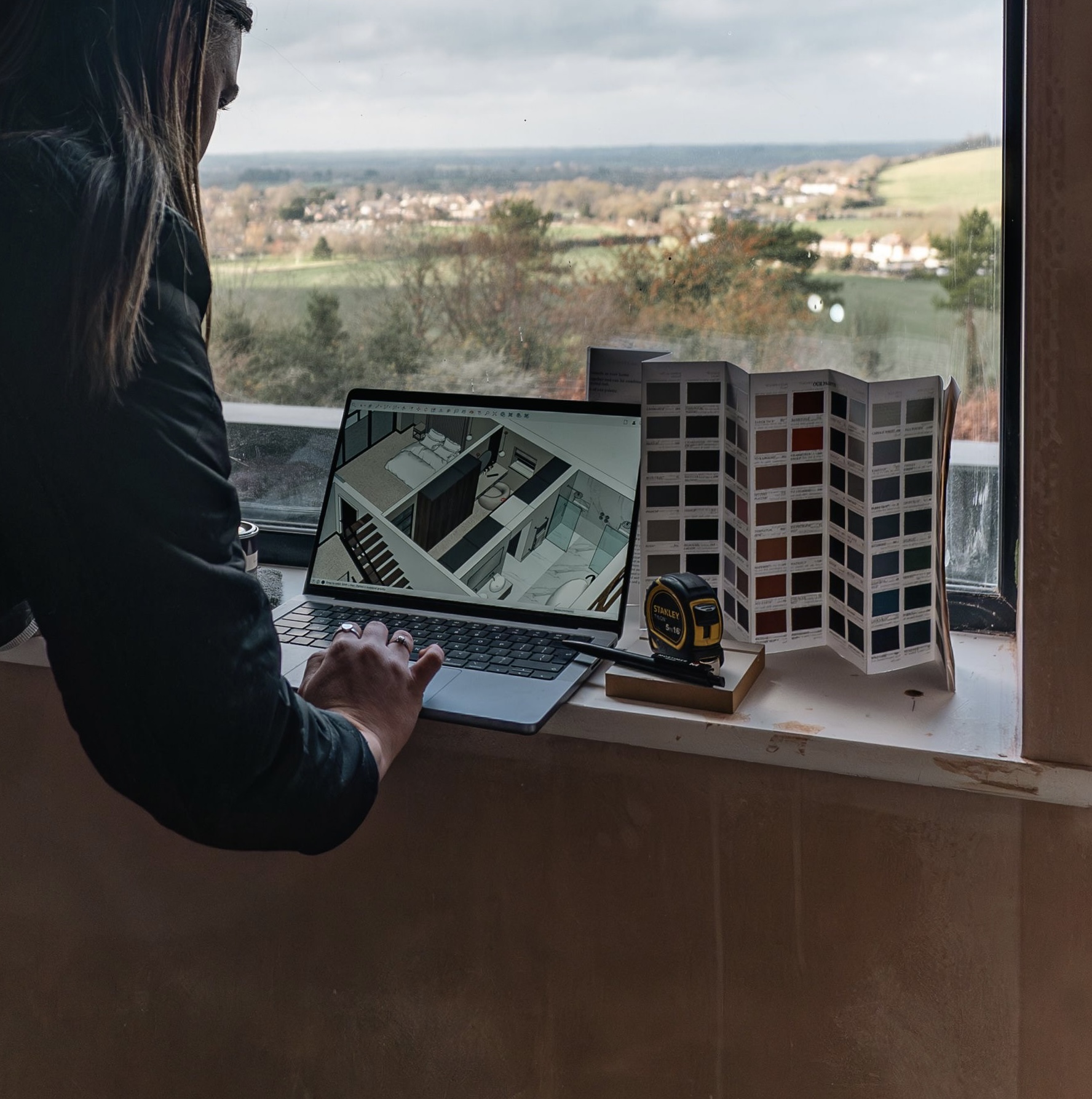 Designer reviewing a three-dimensional layout alongside paint fan decks