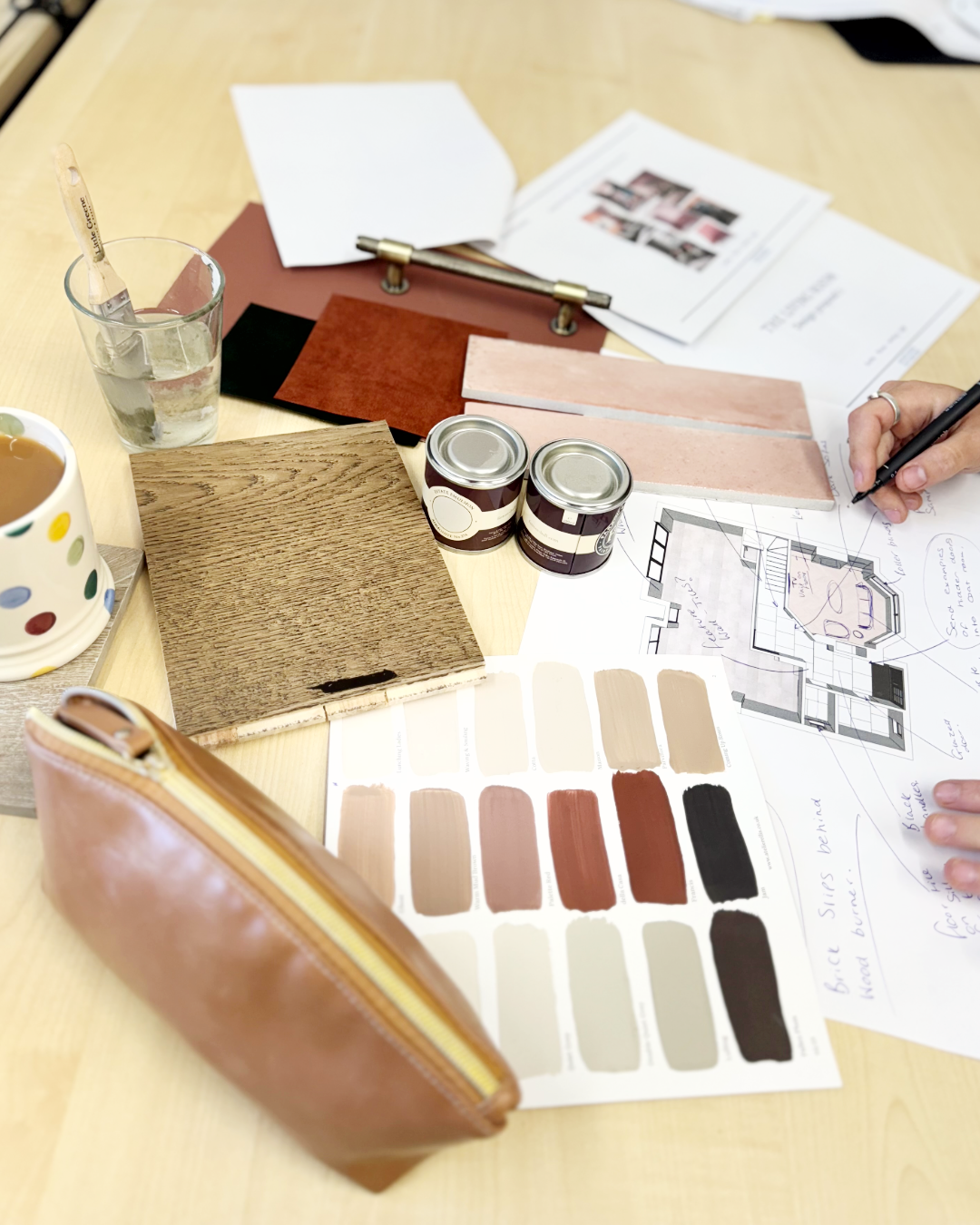 Paint samples, timber and stone finishes laid over an annotated floor plan